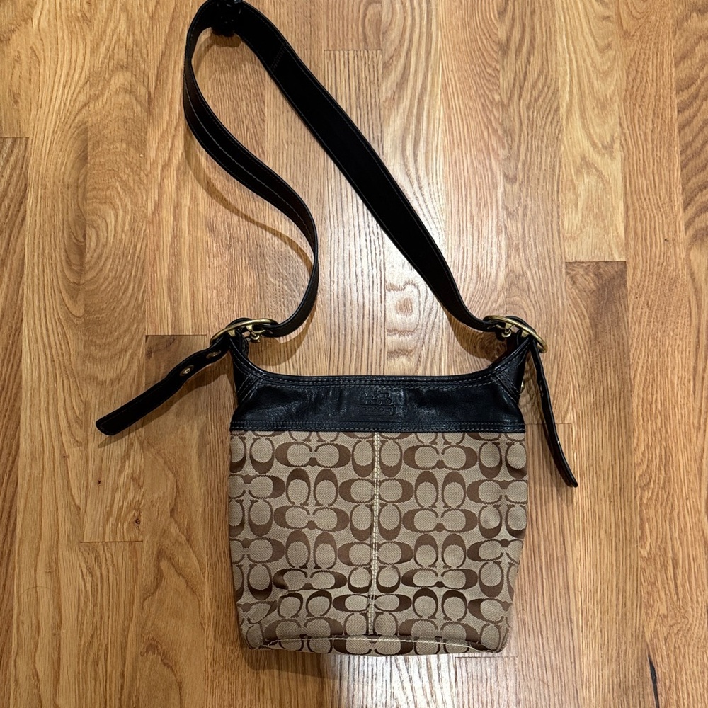 Coach Logo Bucket Shoulder Bag with black leather trim and brass hardware.